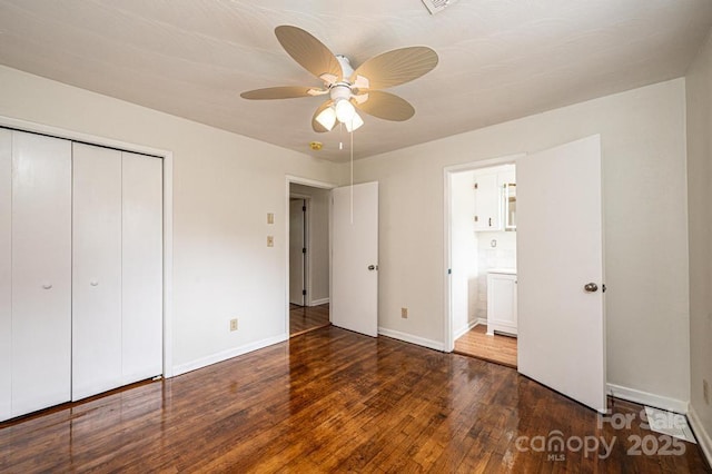 unfurnished bedroom with ceiling fan, dark hardwood / wood-style flooring, and a closet