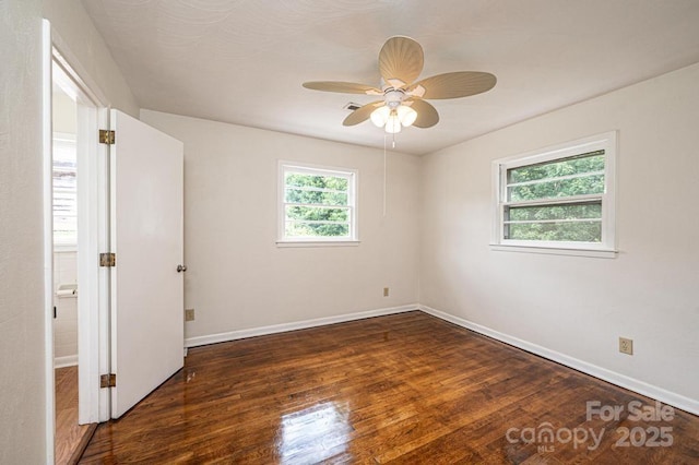 empty room featuring ceiling fan and dark wood-type flooring