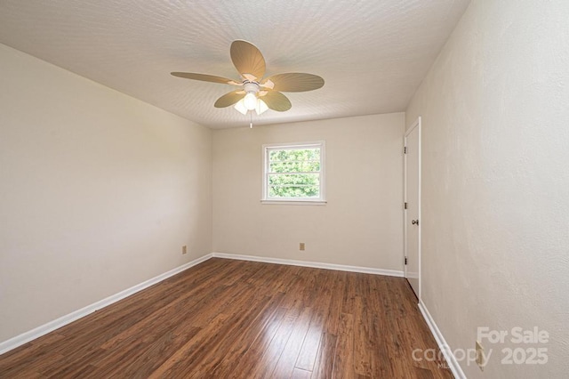 spare room featuring ceiling fan, dark hardwood / wood-style flooring, and a textured ceiling