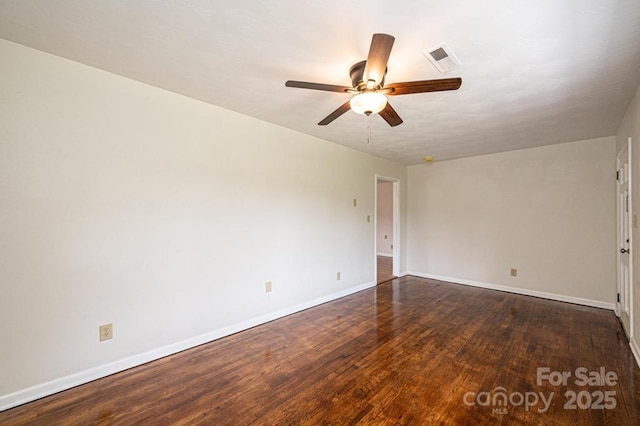 spare room with dark hardwood / wood-style floors and ceiling fan