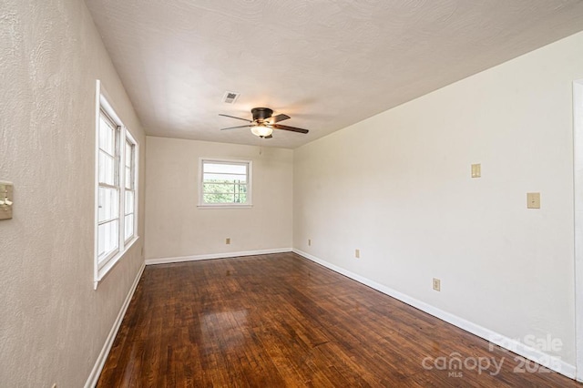 unfurnished room with dark hardwood / wood-style floors and ceiling fan