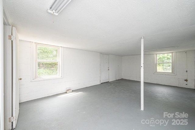 basement featuring a textured ceiling