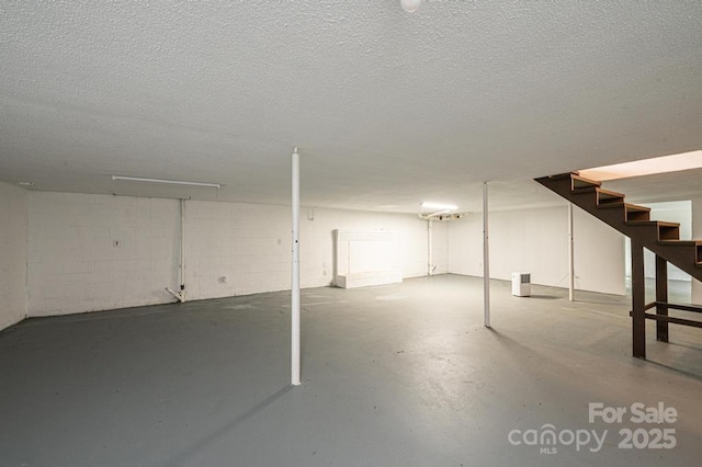 basement featuring a textured ceiling