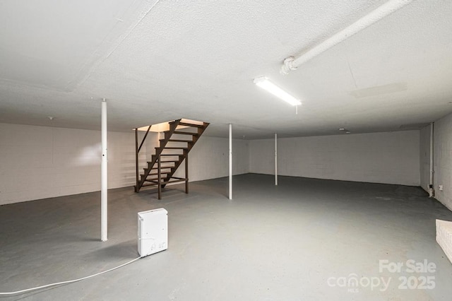 basement featuring a textured ceiling