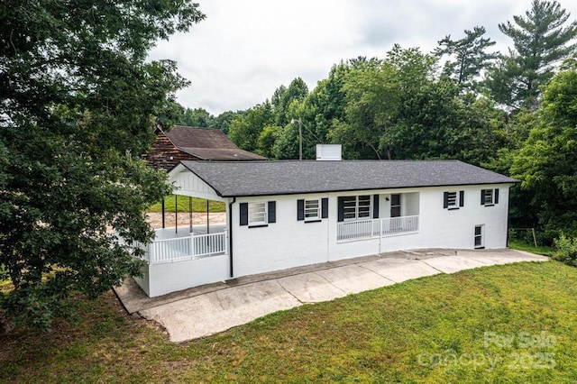 exterior space featuring a porch and a yard