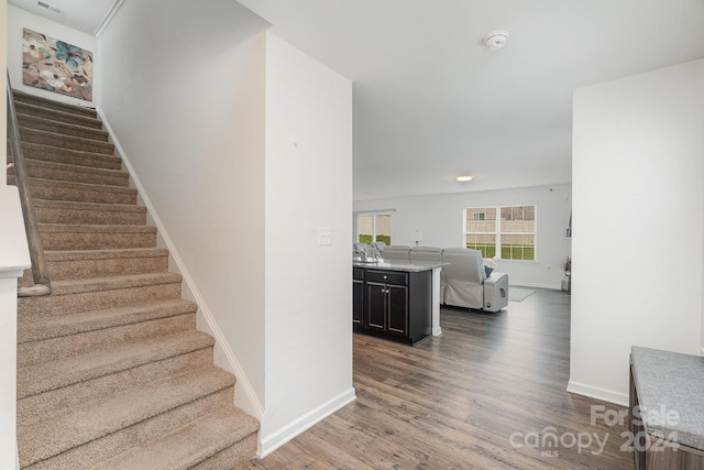 stairway with dark hardwood / wood-style flooring