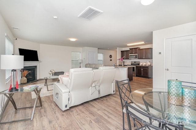 living room with a wealth of natural light and light wood-type flooring