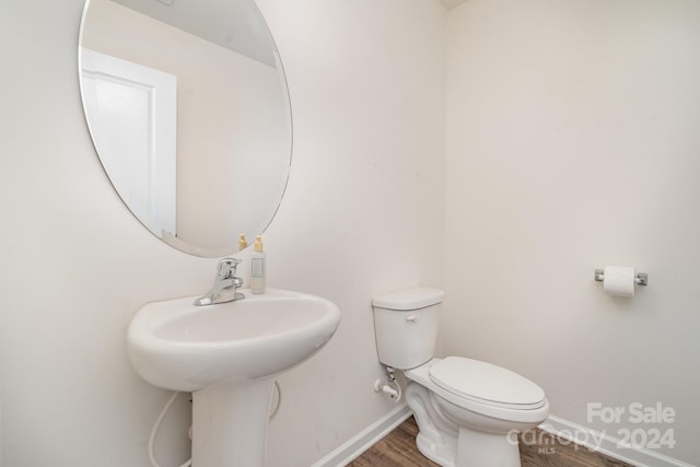 bathroom featuring hardwood / wood-style floors, sink, and toilet