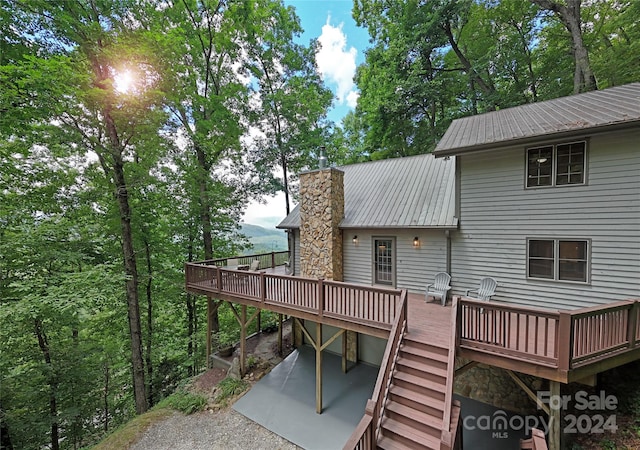 back of property with a wooden deck