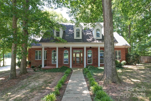 cape cod-style house featuring a porch