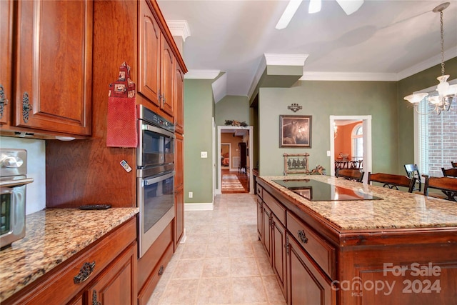 kitchen featuring double oven, hanging light fixtures, ornamental molding, a kitchen island with sink, and black electric cooktop