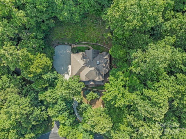 drone / aerial view featuring a view of trees
