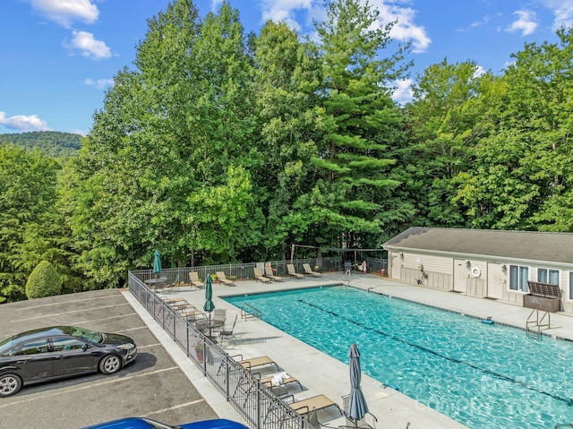 pool featuring a patio and fence