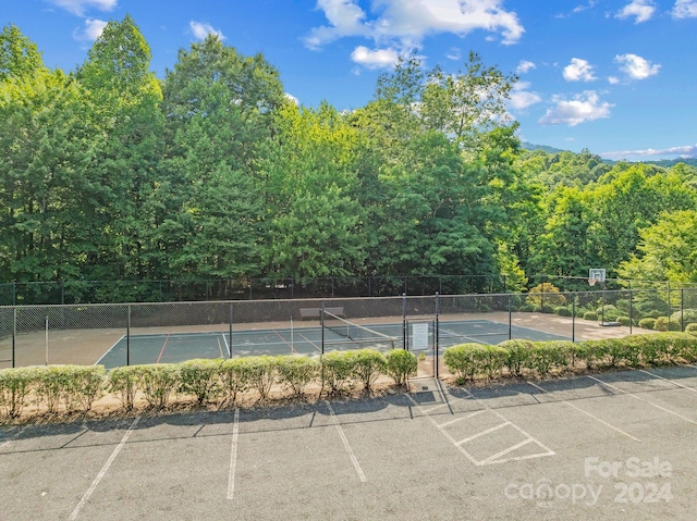 view of parking / parking lot with tennis court