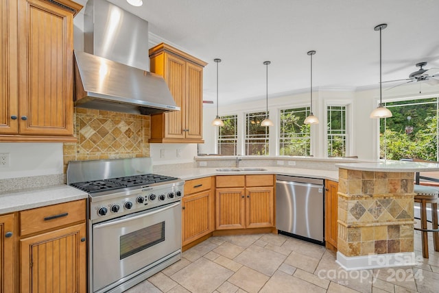 kitchen featuring wall chimney range hood, pendant lighting, light tile patterned floors, ornamental molding, and stainless steel appliances