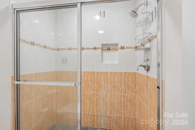 bathroom with a shower with shower door