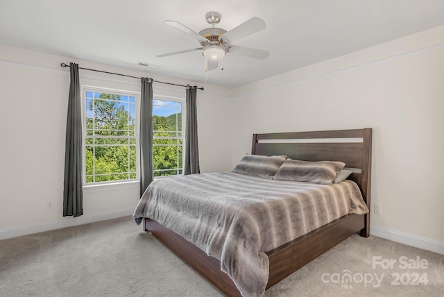 bedroom with a ceiling fan, carpet, visible vents, and baseboards