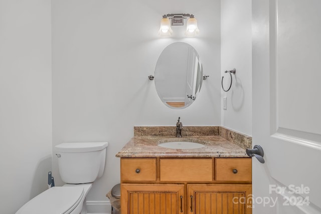 bathroom with toilet and vanity