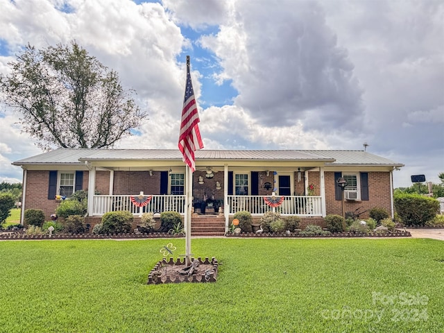 single story home featuring covered porch and a front yard