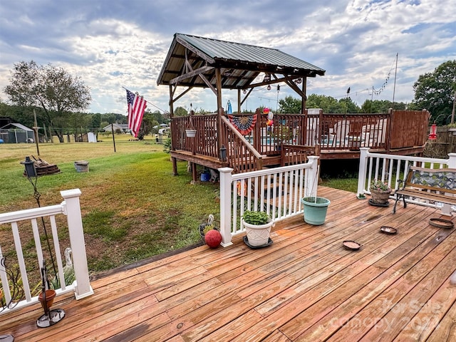 wooden terrace with a gazebo and a yard