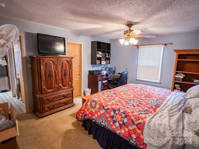 bedroom featuring a textured ceiling, ceiling fan, and light colored carpet