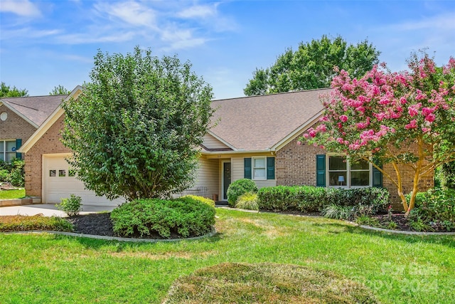 view of front of property featuring a front lawn and a garage