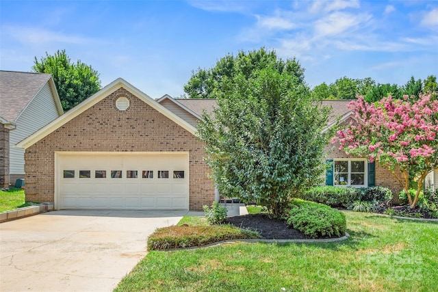 view of front of property featuring a front lawn and a garage