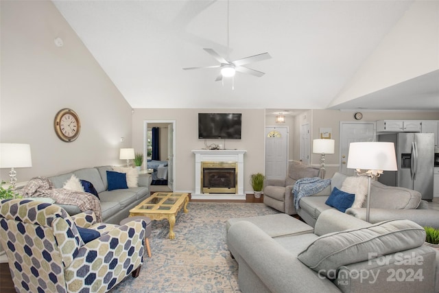 living room featuring ceiling fan, wood-type flooring, and lofted ceiling