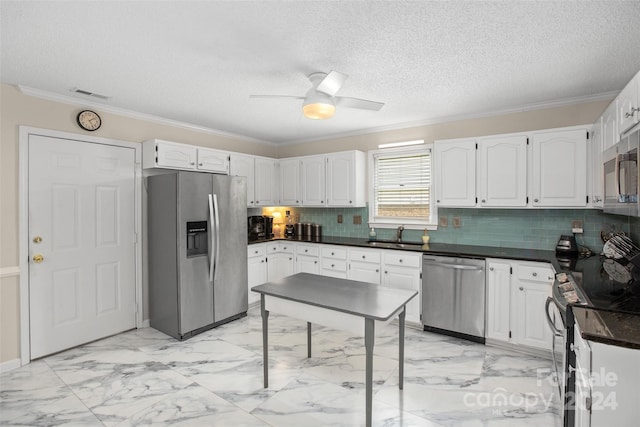 kitchen with white cabinets, backsplash, and appliances with stainless steel finishes