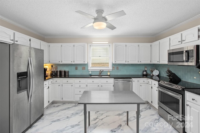 kitchen with white cabinetry, stainless steel appliances, decorative backsplash, ornamental molding, and sink