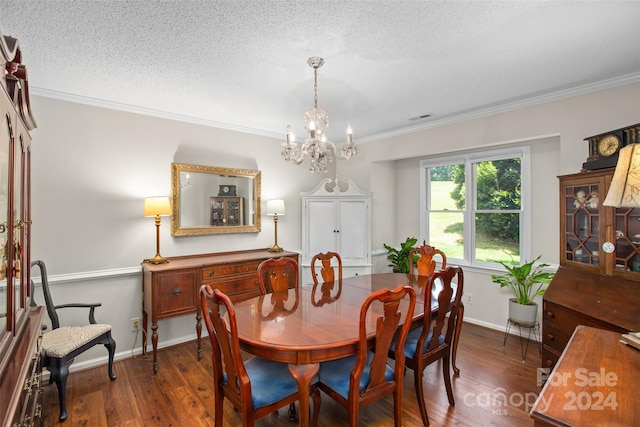 dining room with a textured ceiling, an inviting chandelier, crown molding, and dark hardwood / wood-style floors