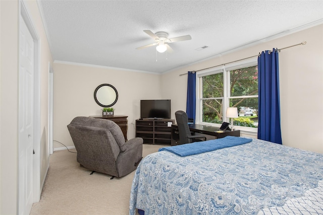 carpeted bedroom with ceiling fan, a textured ceiling, and ornamental molding