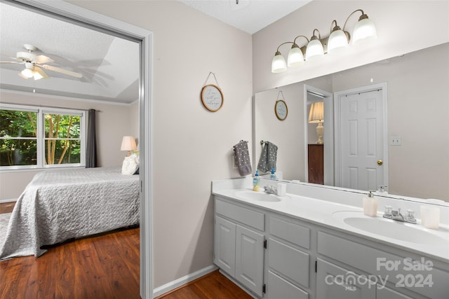 bathroom featuring a textured ceiling, ceiling fan, hardwood / wood-style flooring, and vanity