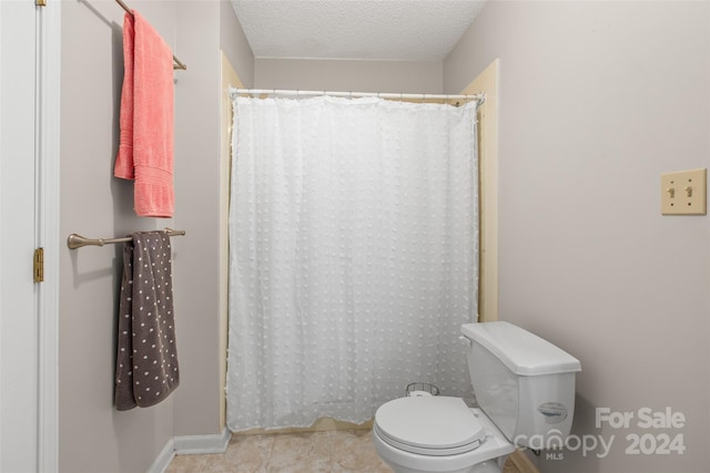 bathroom with a textured ceiling and toilet