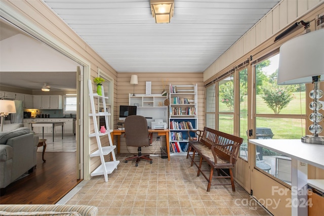 office featuring a wealth of natural light and wooden walls