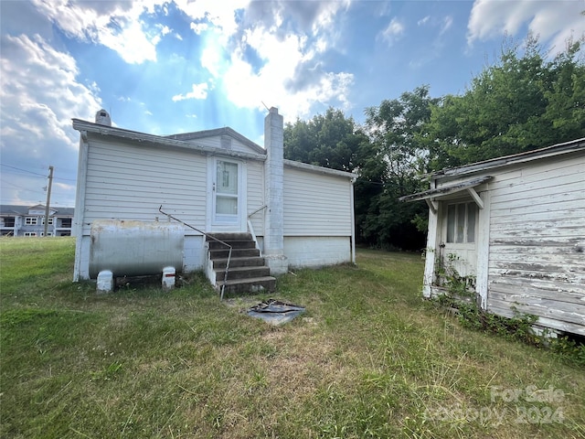 rear view of house with a lawn