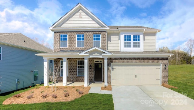 view of front of property with a garage and a front lawn