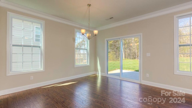 unfurnished room featuring dark hardwood / wood-style floors, crown molding, and plenty of natural light