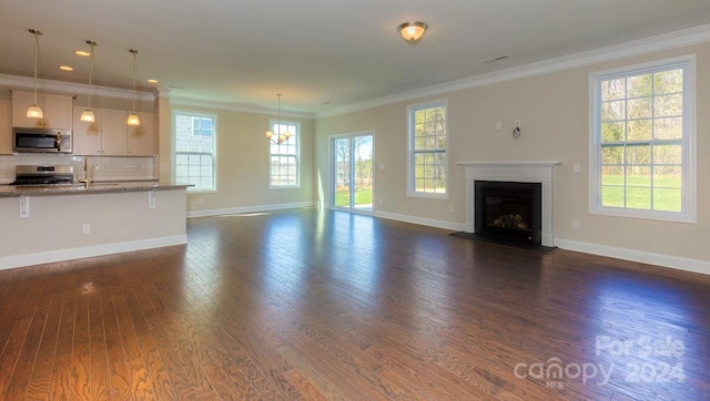 unfurnished living room featuring dark wood-type flooring and ornamental molding