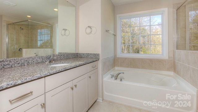 bathroom with separate shower and tub, tile patterned floors, and vanity