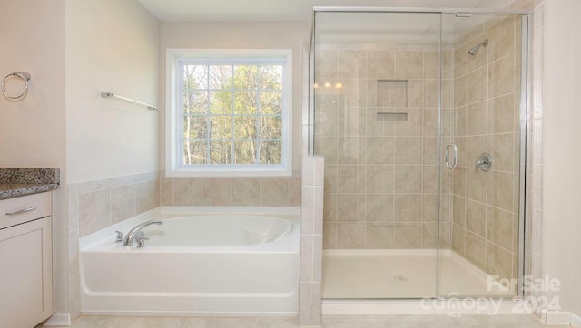 bathroom with vanity, independent shower and bath, and tile patterned floors