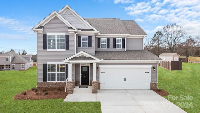 craftsman house featuring a garage, brick siding, a shingled roof, concrete driveway, and a front yard