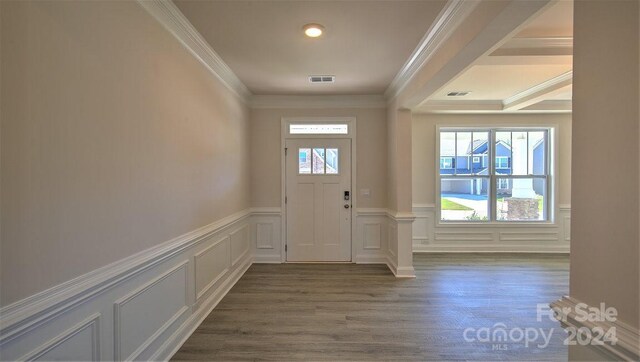 foyer with dark wood-type flooring and crown molding