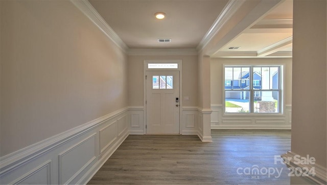 entryway featuring visible vents, wood finished floors, a wealth of natural light, and crown molding