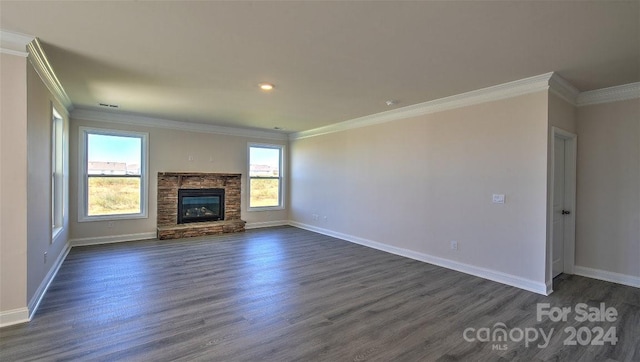 unfurnished living room with a stone fireplace, dark hardwood / wood-style flooring, and ornamental molding