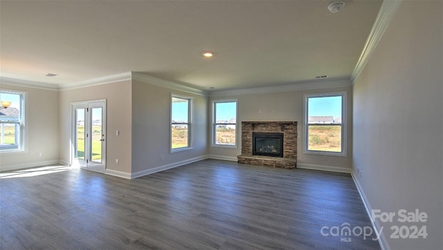 unfurnished living room featuring crown molding, a stone fireplace, and dark hardwood / wood-style flooring