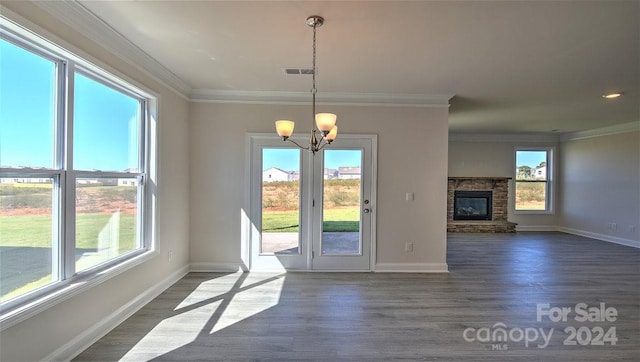 entryway with plenty of natural light, a fireplace, and dark wood-type flooring