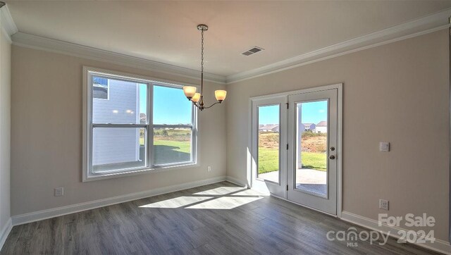 interior space featuring visible vents, an inviting chandelier, dark wood-type flooring, ornamental molding, and baseboards