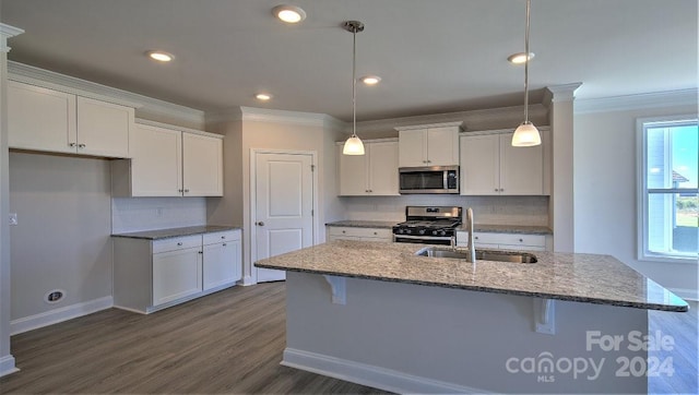 kitchen with wood-type flooring, tasteful backsplash, stainless steel appliances, and ornamental molding