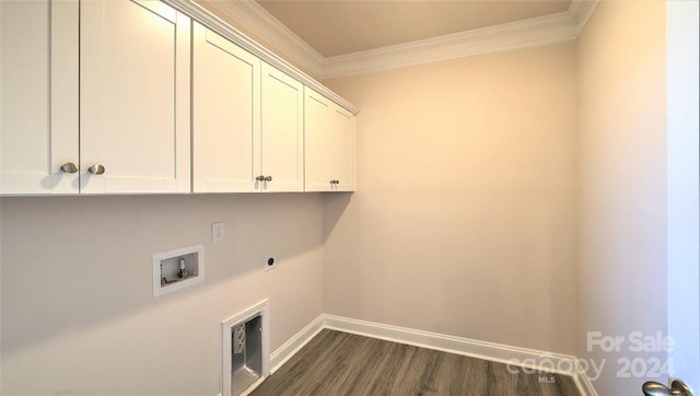 laundry room featuring washer hookup, dark wood-type flooring, crown molding, and cabinets